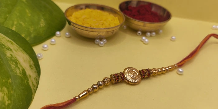 RDS Divine Rakhi with Om Design in the Centre and Roli - Chawal