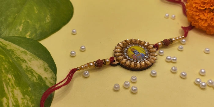 RDS Sunflower Shaped Rakhi with Lord Rama in the Centre and Roli - Chawal